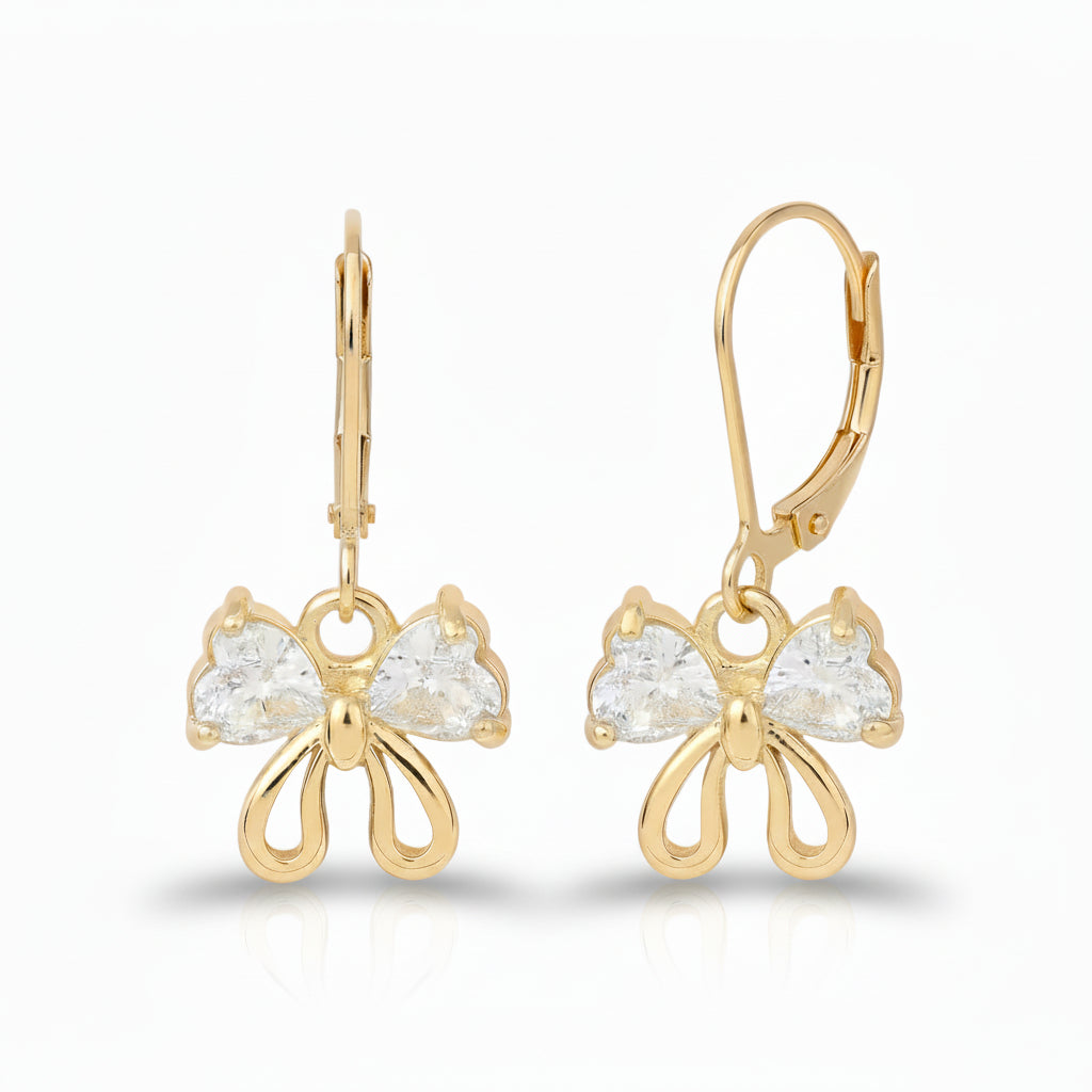 Gold bow-shaped earrings with clear gemstones on a white background